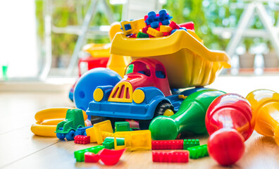 Colorful plastic children toys on the floor