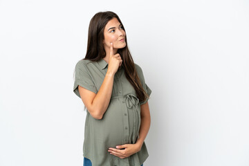 Young Brazilian woman isolated on white background pregnant and thinking