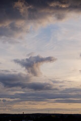 Wolken am Himmel damatische Stimmung abends Unwetter mit Horizont und Windräder Sillhouette Hochformat