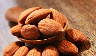 Composition with shellless almonds on a wooden table