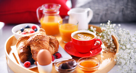 A tray with breakfast on a bed in a hotel room