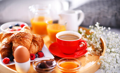 A tray with breakfast on a bed in a hotel room