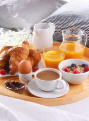Fototapeta na wymiar A tray with breakfast on a bed in a hotel room