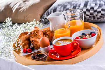 A tray with breakfast on a bed in a hotel room
