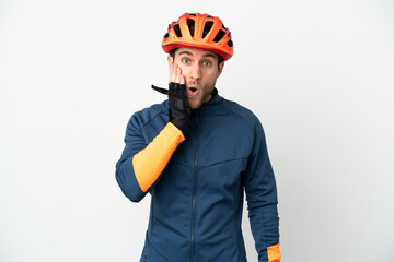 Young cyclist man isolated on white background with surprise and shocked facial expression