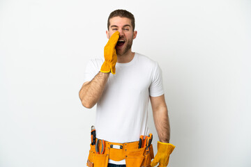 Young electrician man over isolated white wall shouting with mouth wide open
