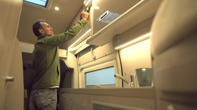 Caucasian Men Preparing For Sleep Inside Class B RV Motorhome
