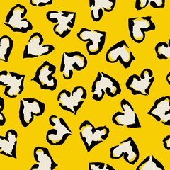 Leopard heart seamless pattern. Vector animal print. Black and white spots on yellow background. Jaguar, leopard, cheetah, panther fur. Leopard skin imitation can be painted on clothes or fabric.