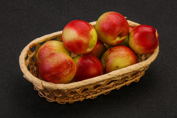 Sweet small nectarines in the basket