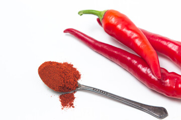 Red hot peppers and red ground peppers on a white background. Chili pepper isolated