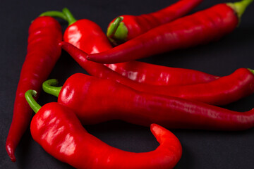 Red hot chili peppers on a black background. Chili pepper isolated