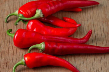 Red hot chili peppers on a wooden background. Ripe harvest