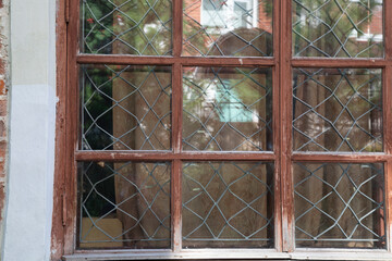 Old wooden windows on the 19th century building.