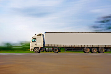 Trailer on the road in motion. Delivery of goods by road.