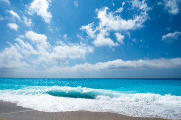 Fototapeta na wymiar Tropical sand beach and blue sky, hot summer day, waves on the beach