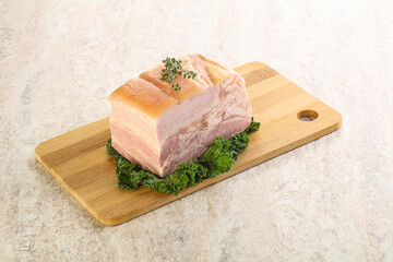 Cut of pork bacon over board