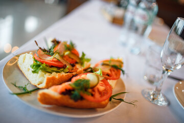 catering canapes with salmon on a plate close-up on the table. selective focus