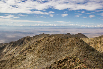 Beautiful Summer scenery: yellow and brown mountains under the blue cloudy sky. Central Asian mountain background. 