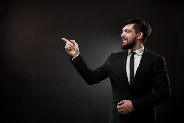 Businessman pointing finger forward and up