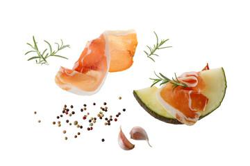 Traditional spanish jamon slices (dried pork meat) with melon and fresh herbs isolated on white