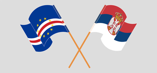 Crossed and waving flags of Cape Verde and Serbia