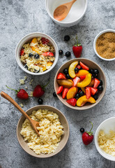 Ingredients for making a summer dessert - plum, nectarines, black currant, strawberry crumble on a gray background, top view