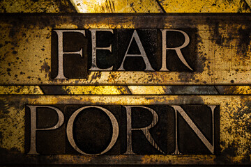 Fear Porn text formed with real authentic typeset letters on vintage textured silver grunge copper and gold background