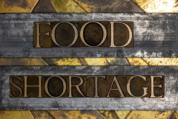 Food Shortage text on vintage textured grunge copper and gold background