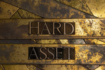 Hard Asset text on textured grunge copper and vintage gold background