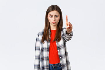 Lifestyle, different emotions, leisure activities concept. Serious concerned young woman showing...