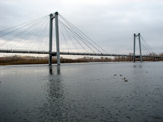 Fototapeta na wymiar Bridge over the Yenisei River in city of Krasnoyarsk. Communal bridge