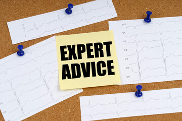Attached to the board are cardiogram clippings and a sticker with the inscription - EXPERT ADVICE