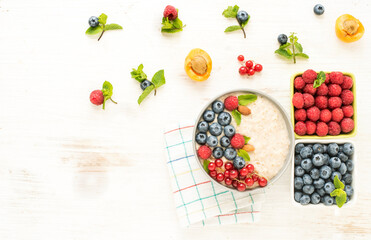 Flat lay for healthy food and morning meals breakfast. Bowl with oatmeal and assorted berries