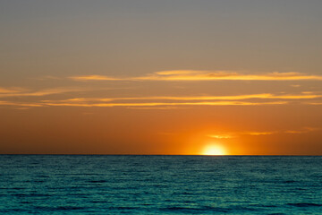 Fototapeta premium Sunset in the ocean. Beautiful seascape. Relaxation and summer beach vacation concept