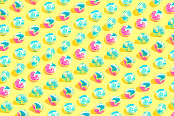 Creative pattern made of colorful macaroons on yellow background. Dessert and confectionary concept.