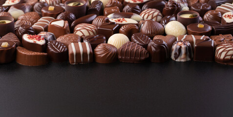 chocolate candy on black background, delicious treat for snack