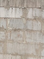 Pile of white bricks attached to the wall of the house