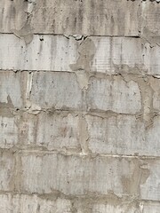 Pile of white bricks attached to the wall of the house