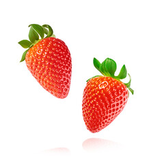 Fresh raw ripe strawberry with green leaves falling in the air, food levitation