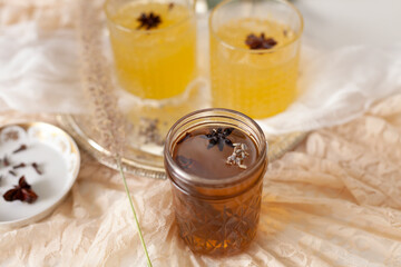 Southern style sweet tea cocktail with two glasses of orange blossom scented cocktails in the background