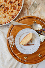 Southern baked rice pudding with spoon surrounded by wild foraged flowers