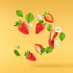Fresh raw ripe strawberry with green leaves falling in the air, food levitation