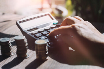 bookkeeper using calculator counting finances taxes fees accounting calculate bills money planning budget loan payment concept pay online on computer do paperwork work at home office desk