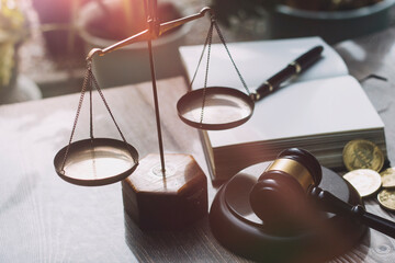 Justice and law concept.Male judge in a courtroom with the gavel, working with, computer and...