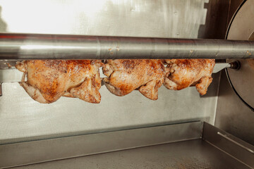 Whole chickens on a rotisserie 