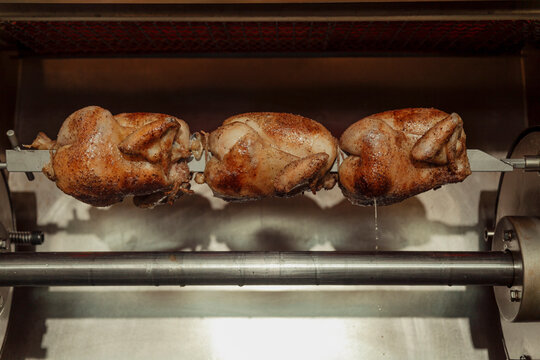 Whole chickens on a rotisserie 
