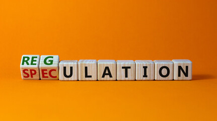 Speculation or regulation symbol. Turned cubes and changed the word speculation to regulation. Beautiful orange table, orange background, copy space. Business, speculation or regulation concept.