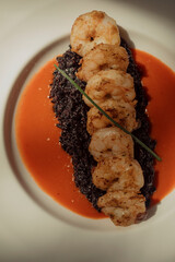 Shrimp and black rice dish at a restaurant