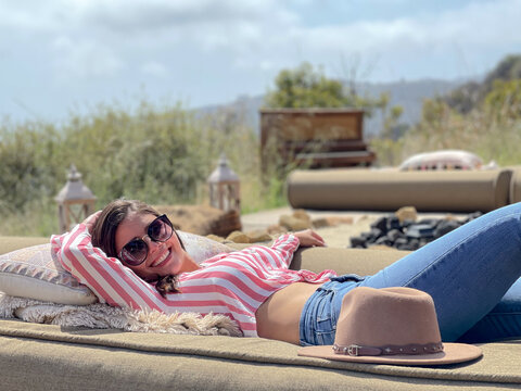 Beautiful woman relaxing and resting in a luxury camping place in Malibu, California
