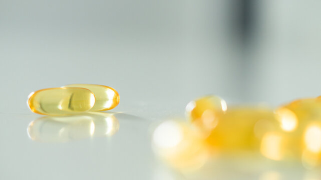 Omega 3. Vitamin drops pill capsule. Shining golden drop of essence. Nutrition skin care design for cosmetic procedures.